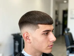 Kobieta z modną grzywką dobraną do okrągłej twarzy, prezentująca elegancką i nowoczesną fryzurę.